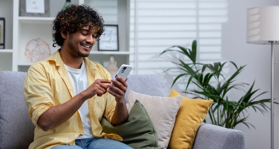 Homeowner navigating a home security app on his smartphone